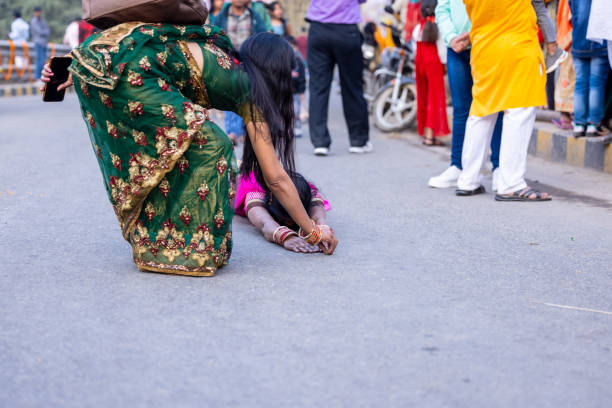 Ghaziabad, Uttar Pradesh, India - November 2023: Portrait of an indian woman performing chhath rituals by laying down on street till the river bank to worship in ethnic clothes.