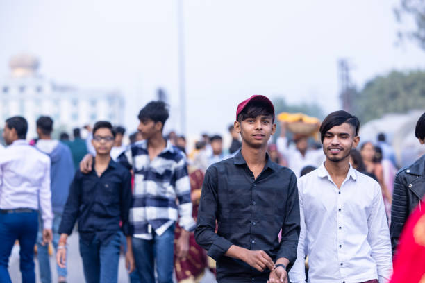 Ghaziabad, Uttar Pradesh, India - November 2023: Portrait of an hindu male devotee walking towards the fair ground to perform the chhath puja near river bank along with their family members.