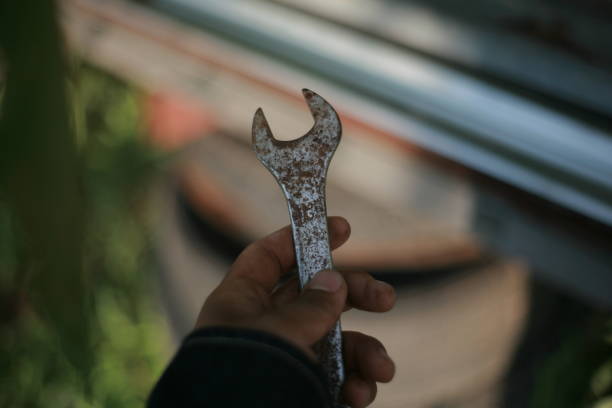 istock holding wrench in hand 2162671919