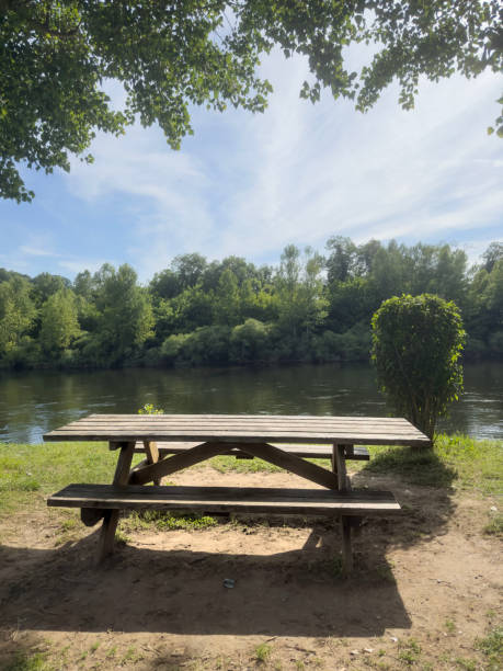 istock empty wooden picnic table in the park by river 2162671964