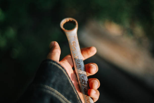istock holding wrench in hand 2162672189