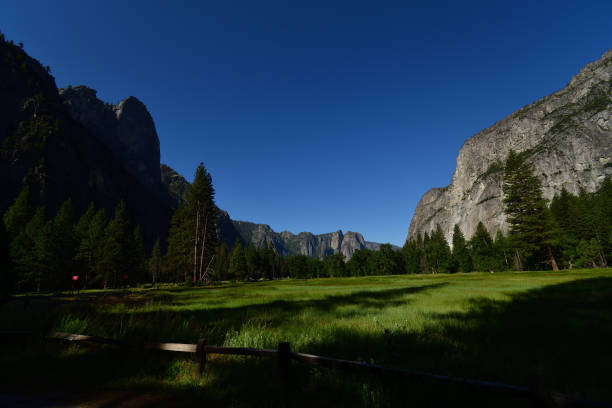 Yosemite Valley forest, granite cliffs, waterfalls, and Merced River.