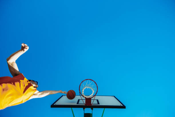 istock Basketball player dunks the ball into the hoop 2162674542