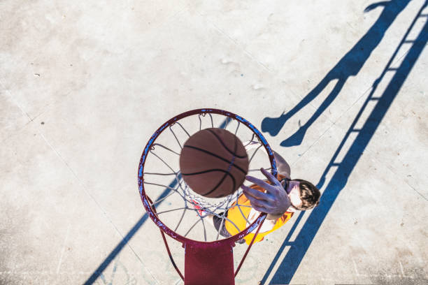 istock Man making a basket in basketball 2162674944