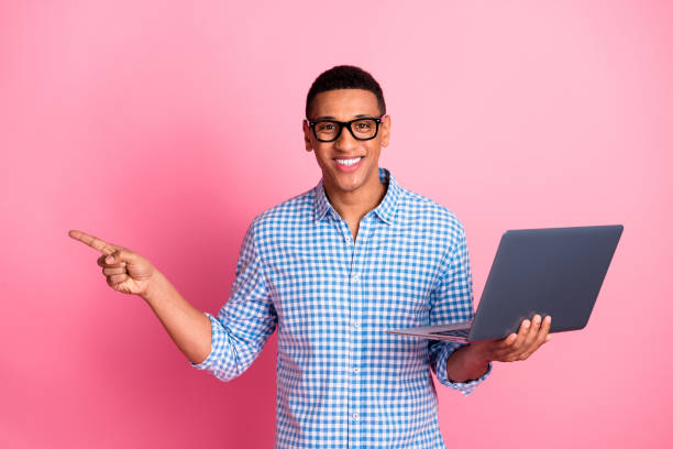 istock Photo of funky cool guy dressed checkered shirt typing modern device pointing emtpy space isolated pink color background 2162676073