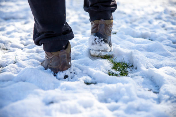 Man legs Hiking on the snow