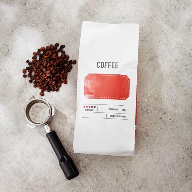 Coffee package and filter holder. Blank coffee bag and some roasted coffee beans with a portafilter flat lay