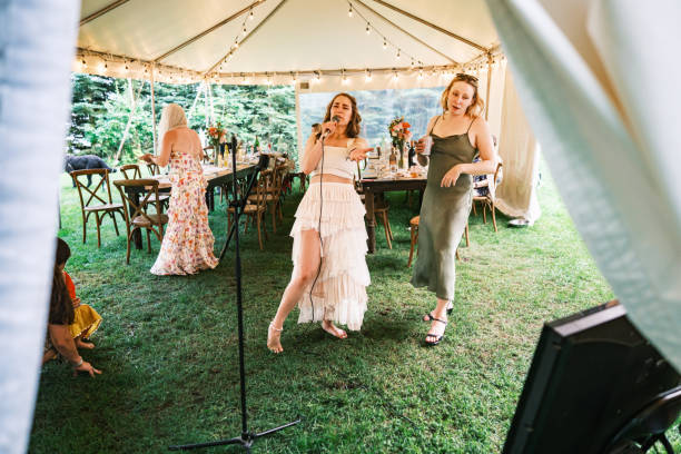 istock Bride and her girlfriends singing karaoke at the wedding party 2162688158