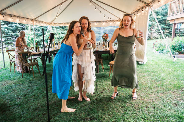 istock Bride and her girlfriends singing karaoke at the wedding party 2162688172