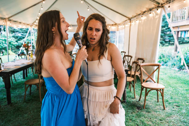 istock Bride and her girlfriends singing karaoke at the wedding party 2162688194