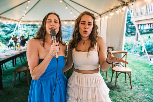 istock Bride and her girlfriends singing karaoke at the wedding party 2162688205