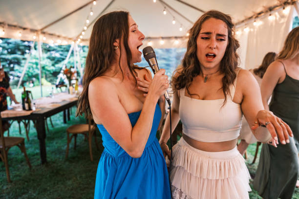 istock Bride and her girlfriends singing karaoke at the wedding party 2162688207