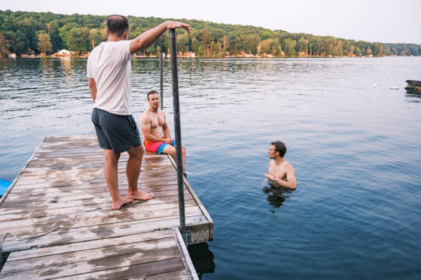 istock Young men having fun at the lake 2162688229