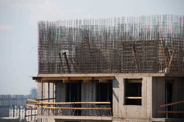 A large building is under construction and has a large crane