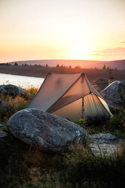 istock Camping in mountains by lake at sunrise 2162688369