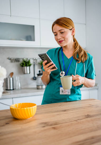 istock Young medical nurse using phone at home 2162688551