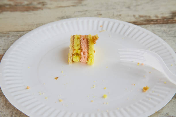 istock A finished piece of sponge cake on a white disposable plate on a table close-up, fruit sponge, rustic home baking 2162689530
