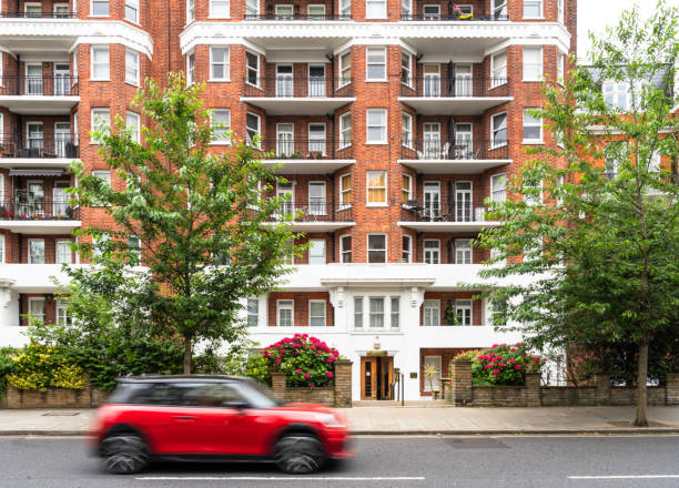 Motion blur as a car passes a traditional brick-built block of luxury flats in Hampstead, London.