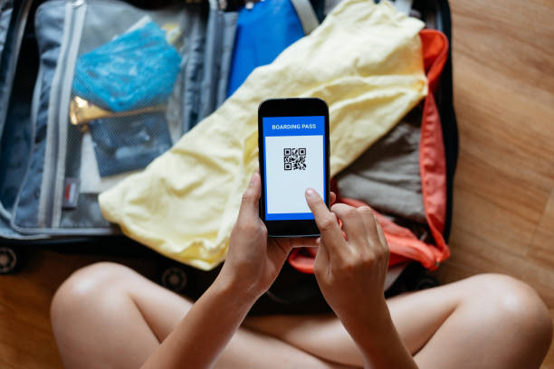 istock Young woman checking electronic boarding pass on smartphone 2162691533