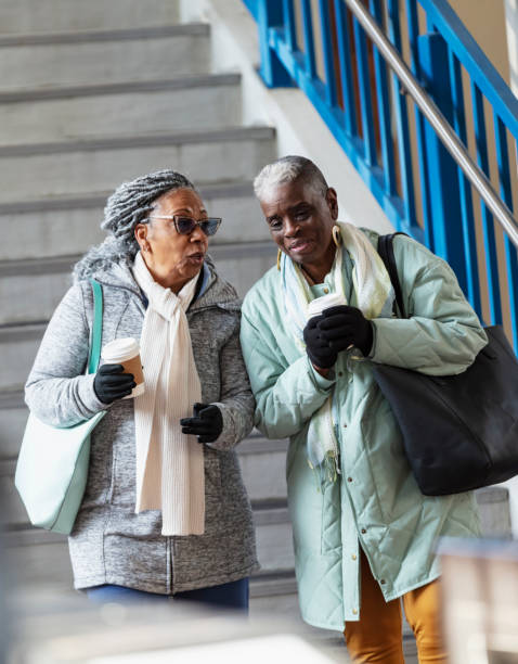 istock Two senior black women exiting train station, talking 2162692093
