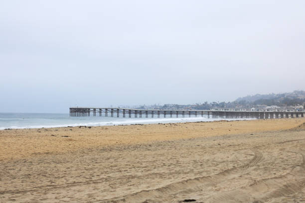 Empty Pacific Beach in the early morning with a view of historical Crystal Pier in the distance, San Diego, Southern California