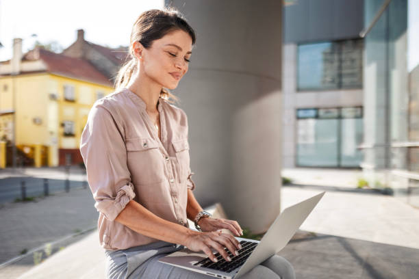 istock Young Woman with Laptop Outside 2162695881