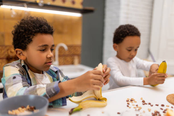 Healthy breakfast. Two siblings sitting at the table and having breakfast
