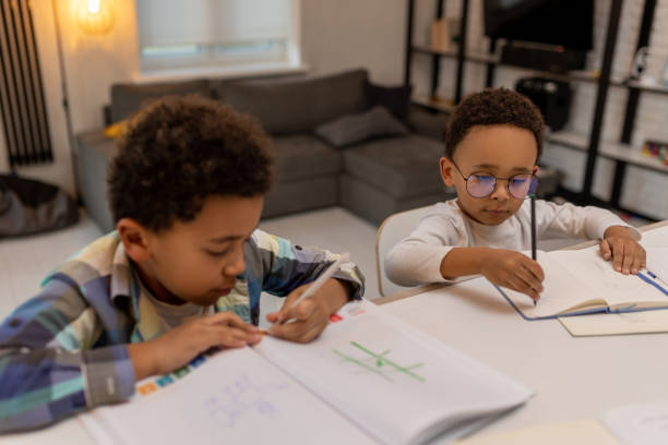 istock African american boys doing lessons and writing something in a notebook 2162697842