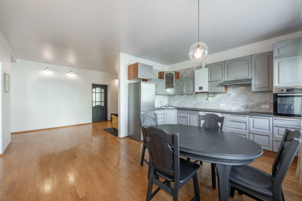 istock Classic Kitchen Interior and Dinning Table. Wooden Floor, Oven, Kettle, Microwave and Glass. Minimalistic Interior Design 2162699088