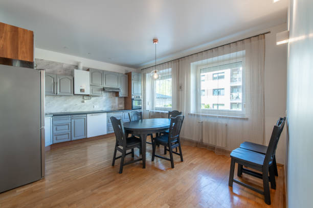 istock Classic Kitchen Interior and Dinning Table. Wooden Floor, Oven, Kettle, Microwave and Glass. Minimalistic Interior Design 2162699096