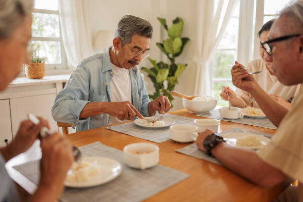 istock Old friends enjoying a meal together 2162705052