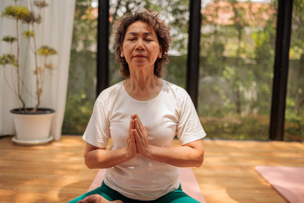 istock Mature woman meditating 2162705935