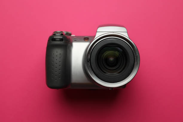 Digital single-lens reflex professional camera on wooden table and dark background