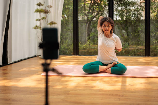 istock Female yoga instructor hosting online class 2162707186
