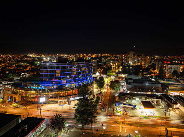 An apartment building at night, with illuminated windows reflecting a vibrant urban community life