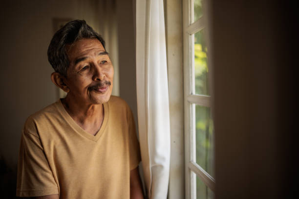 istock Elderly man looking out the window 2162707923