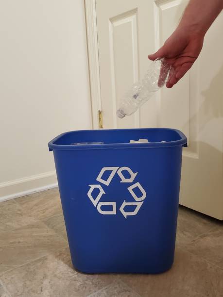 istock Recycling in a Blue Recycle Bin 2162708128