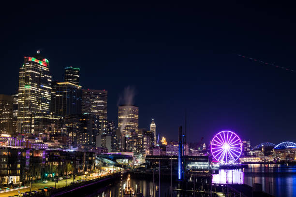 istock Vibrant City Skyline with Illuminated Ferris Wheel at Night 2162708422