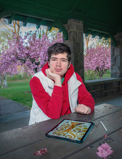 istock Creative expression in nature. Young autistic artist explores digital art in James Park, Madison, NJ 2162709737
