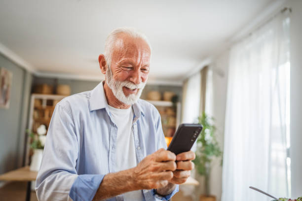 istock Senior caucasian man use a mobile phone at home 2162709869