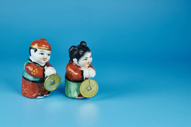 Couple of ceramic Chinese exhibited with ancestral clothing of their culture