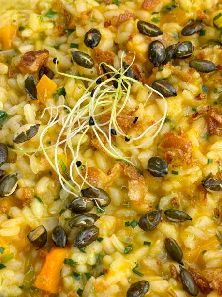 istock Full frame image of pumpkin risotto with pumpkin seed garnish, rice dish, restaurant meal, surface level, elevated view 2162714172