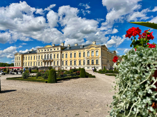 Rundale, Latvia - July 6, 2024 - Tram with tourists pulls up in front of the popular tourist attraction of Rundale Palace. The palace was built in between 2 periods - from 1736 until 1740 and from 1764 until 1768.