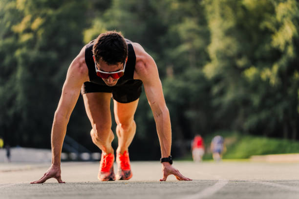 istock Athlete preparing to start in running position with copy space 2162720038