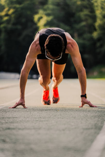 istock Pro runner ready to go during the race on the running track. Vertical 2162720040