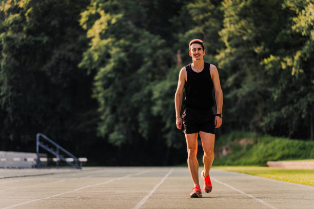 istock Athlete smiling as he returns from training at the athletics track. Copy space 2162720072
