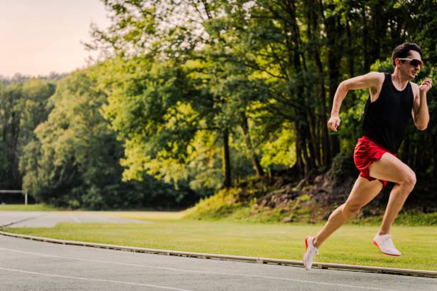 istock Young male sprint runner in the track race with copy space 2162720090