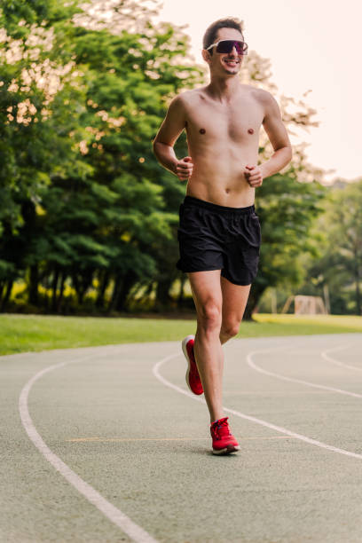 istock Shirtless athlete and sunglasses enjoying running outdoors. Vertical 2162720169