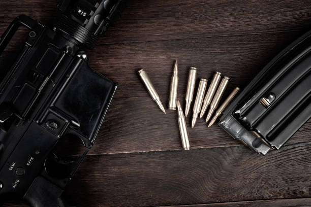 istock Rifle and Ammunition with magazine on wooden table 2162722304