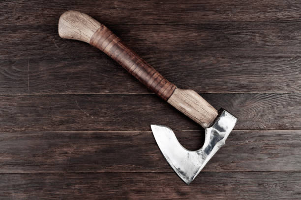 battle axe with wooden handle on wooden background